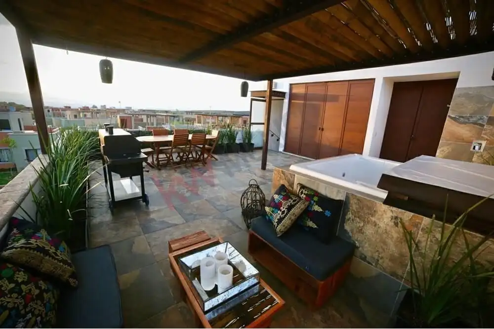 Rooftop terrace in San Miguel de Allende featuring a Jacuzzi, outdoor seating, and panoramic city vi.