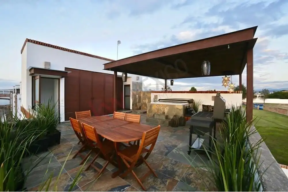 Outdoor rooftop terrace with dining area, Jacuzzi, and lounge space in a San Miguel de Allende home.