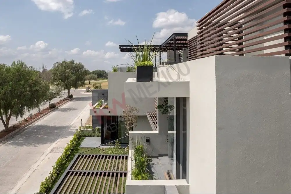 Contemporary home in Ventanas Golf Club with sleek design and outdoor greenery.