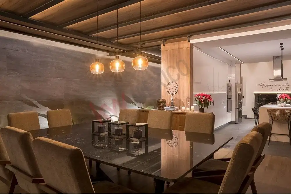 Elegant dining room with modern decor and warm lighting.