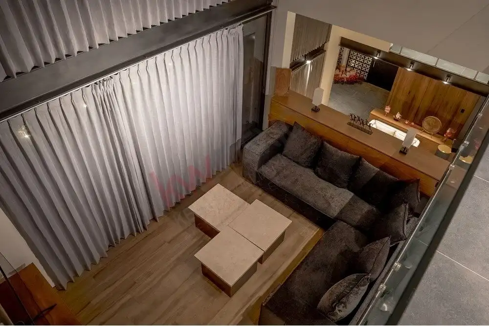 Elegant living room with modern decor and large windows in Ventanas Golf Club property.
