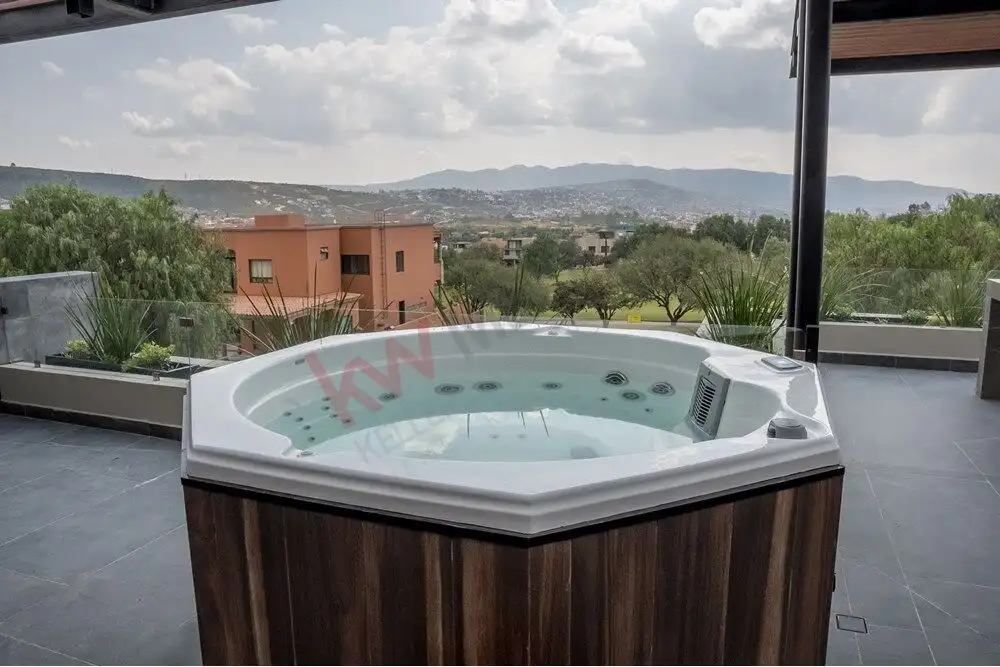 Hot tub on terrace overlooking San Miguel de Allende landscape.