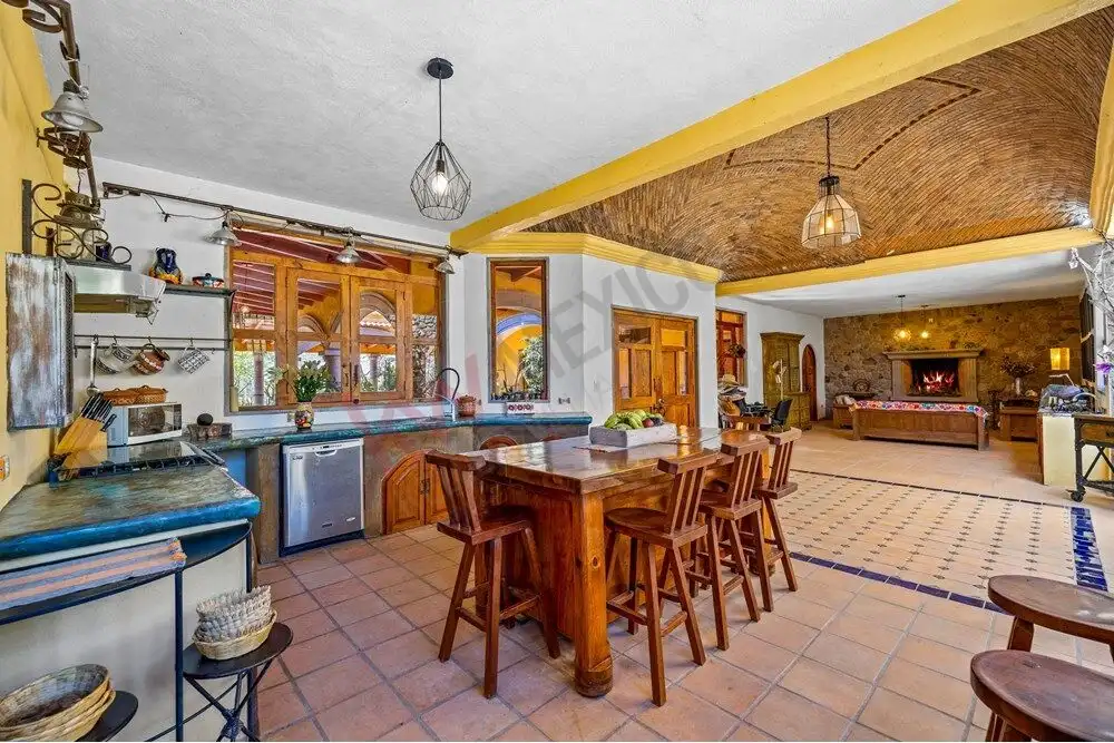 Spacious kitchen with wooden cabinets, island, and modern appliances in a large country estate.