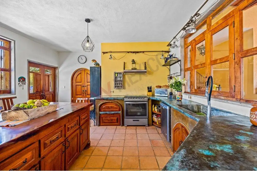 Ranch for Sale in San Miguel de Allende with spacious country estate kitchen and rustic wooden accen.