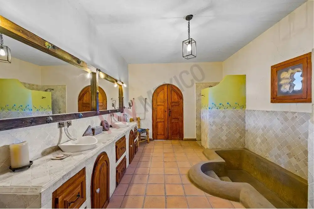 Bathroom with traditional rustic design, featuring a large bathtub, wooden cabinetry, and vintage de.