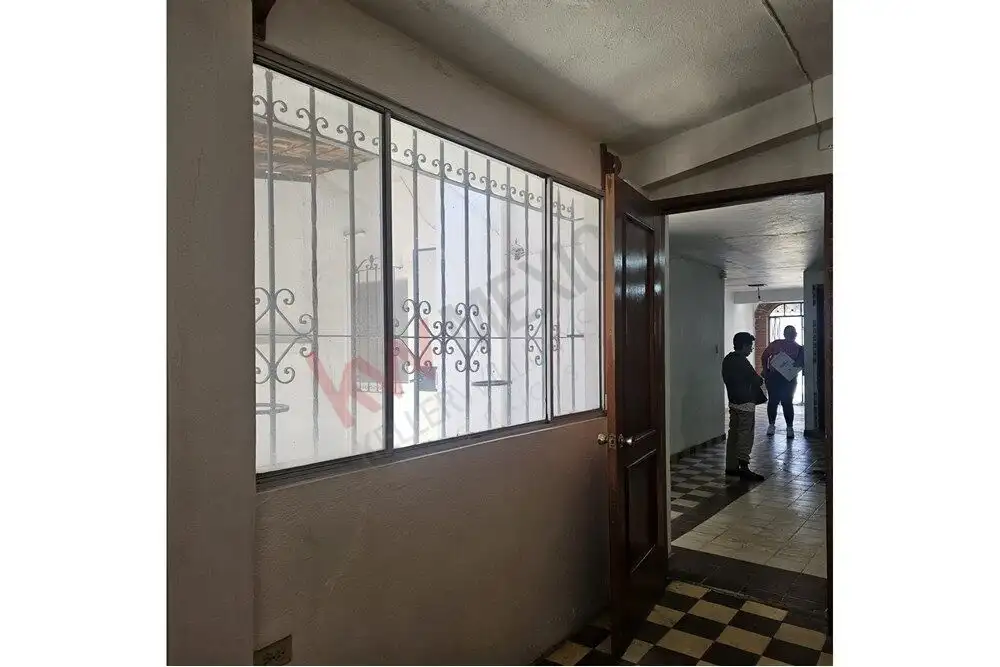 Cozy San Miguel de Allende Home Entrance Bright window with decorative iron grille in a charming San Miguel de Allende house.