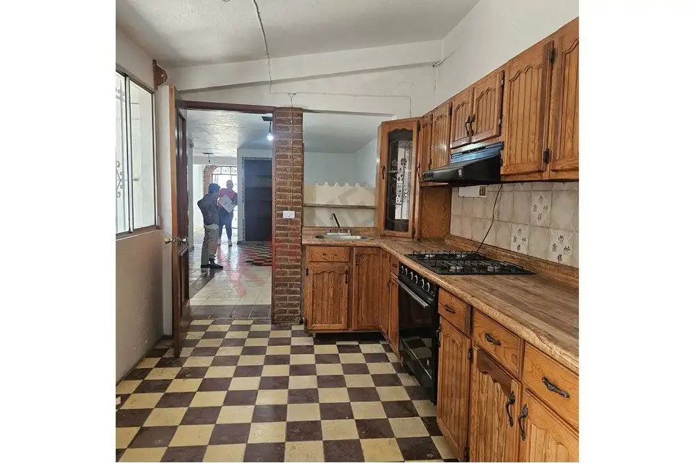 Story Home in San Miguel de Allende Charming kitchen with wooden cabinets and checkered flooring near downtown San Miguel de Allende.