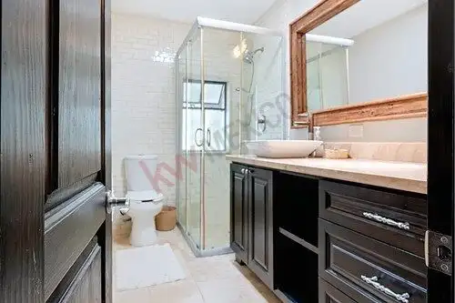 Bright bathroom with modern shower and white tile accents in a charming home in Colonia Guadalupe.