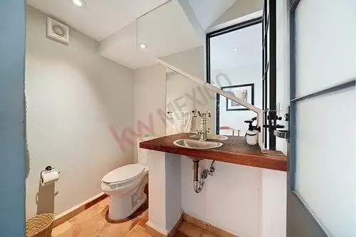 Bright bathroom with modern fixtures and a small window for natural light. Perfect for a cozy home i.