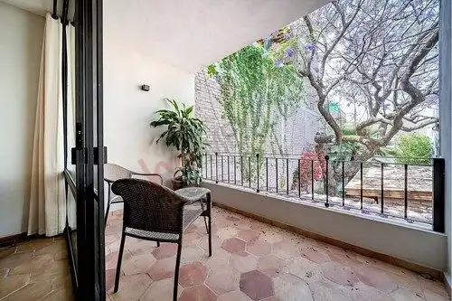 Balcony overlooking lush trees and garden in a home for sale in Colonia Guadalupe, San Miguel de All.