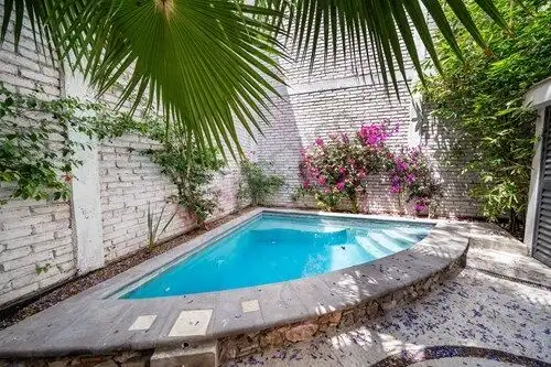 Beautiful private pool surrounded by lush greenery in a San Miguel de Allende home. Perfect for rela.