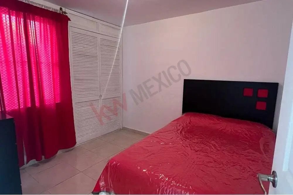 Cozy 2-Bedroom Home in San Miguel de Allende Interior view of a bedroom with red bedding and curtains in Guadalupe Mexiquito, San Miguel de Allen.