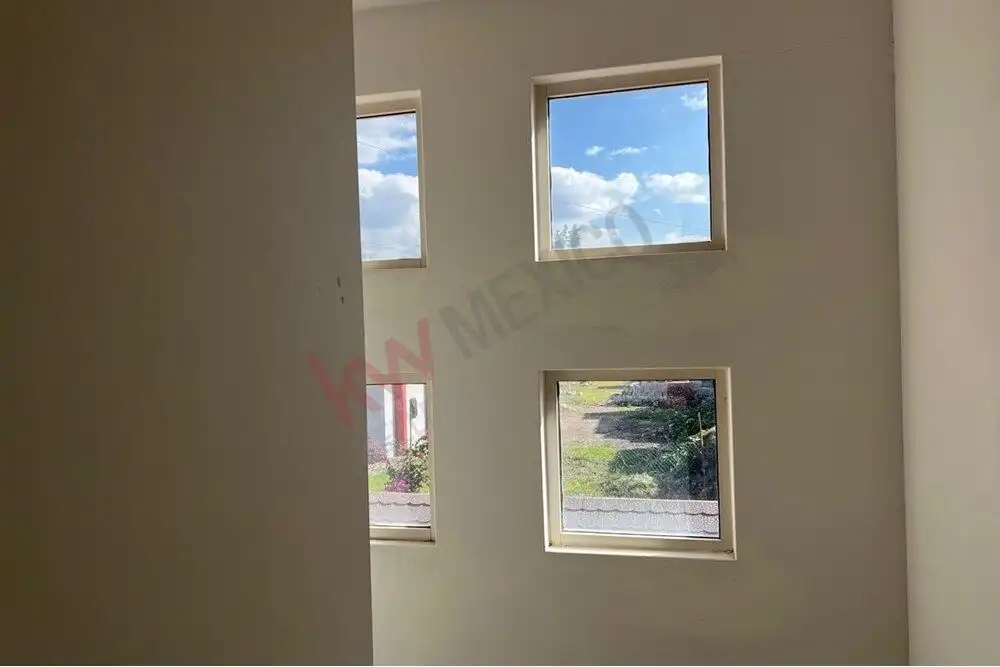 Modern interior with four square windows in San Miguel de Allende. Four square windows offering bright natural light and scenic views in a contemporary home.