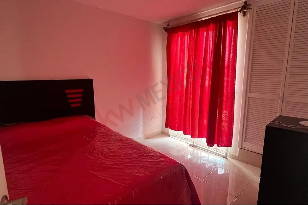 Home in Guadalupe Mexiquito, San Miguel de Allende Cozy bedroom with red curtains and natural light in a charming Mexican home.