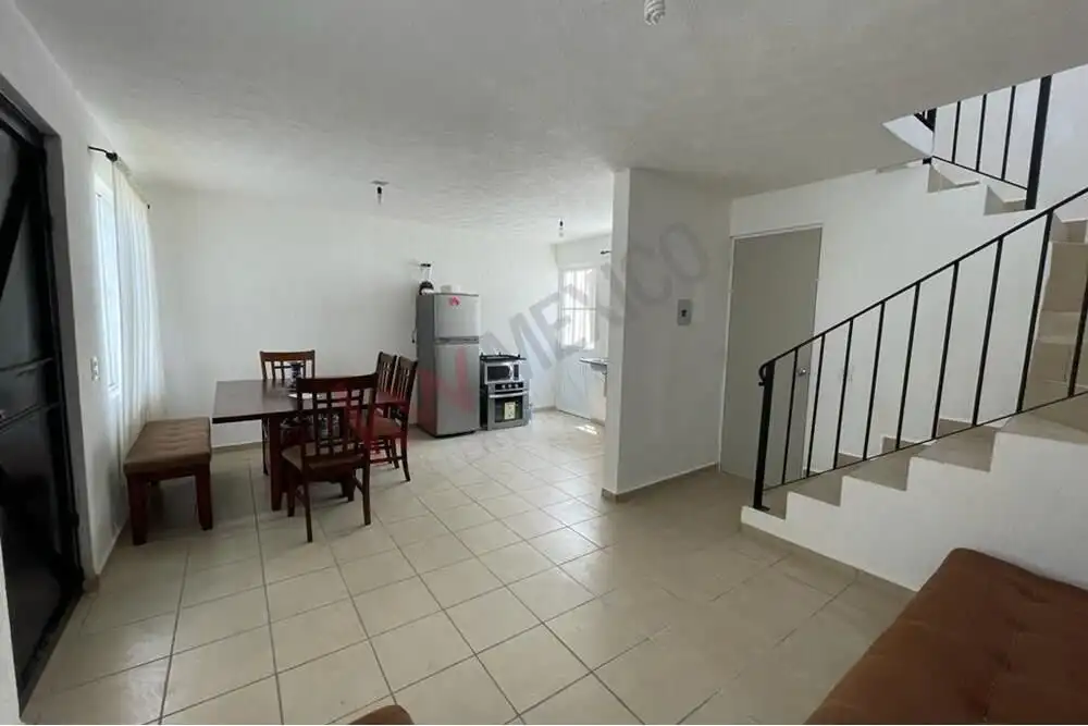 Affordable Home in San Miguel de Allende Spacious living area with dining space and staircase in Casa Durazno, San Miguel de Allende’s La Vis.