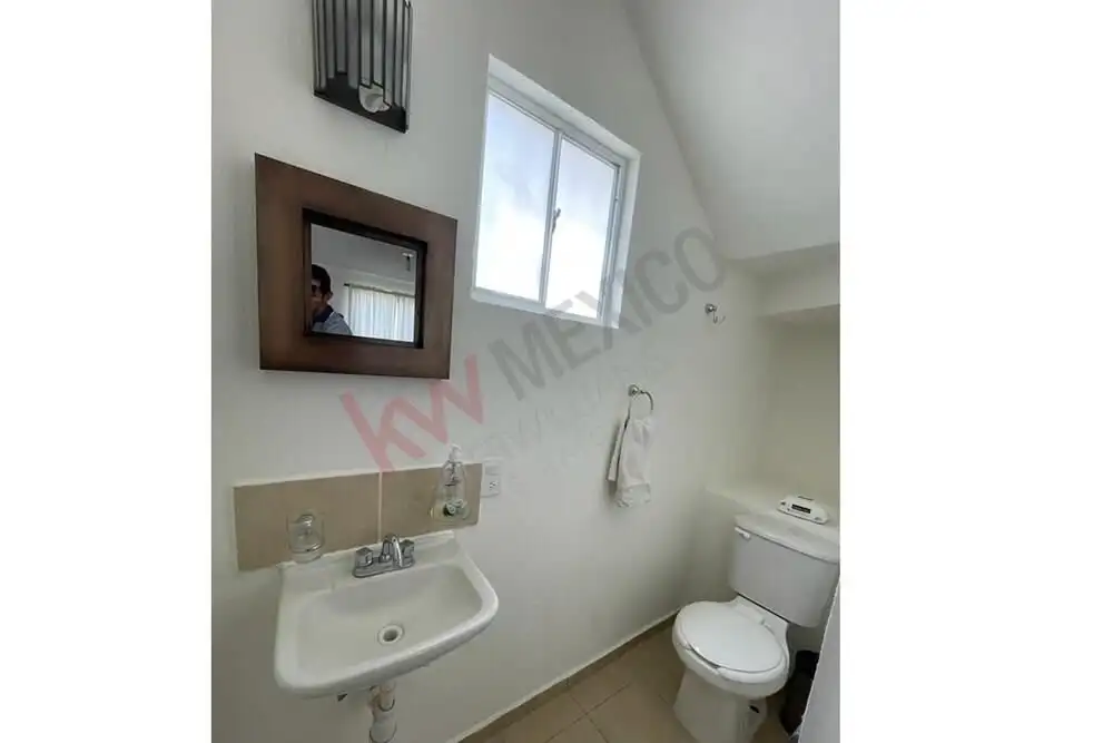 Cozy San Miguel Bathroom Bright bathroom with small window and modern fixtures in San Miguel de Allende.