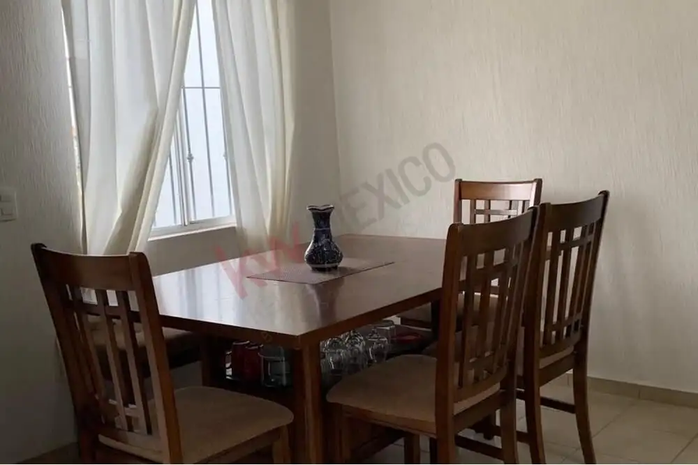 Casa Durazno Dining Area Cozy dining room with wooden table and chairs in San Miguel de Allende.