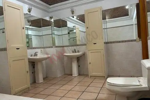 Bright bathroom with dual sinks, large mirror, and modern fixtures in Rancho Los Labradores.