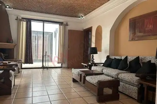 Interior view of a single-story home with a large living room and sliding glass doors in San Miguel.