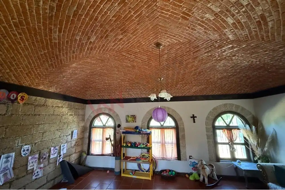 Unit Home Interior in San Miguel de Allende Spacious living room with brick vaulted ceiling, large windows, and colorful decor in Villa de Los F.