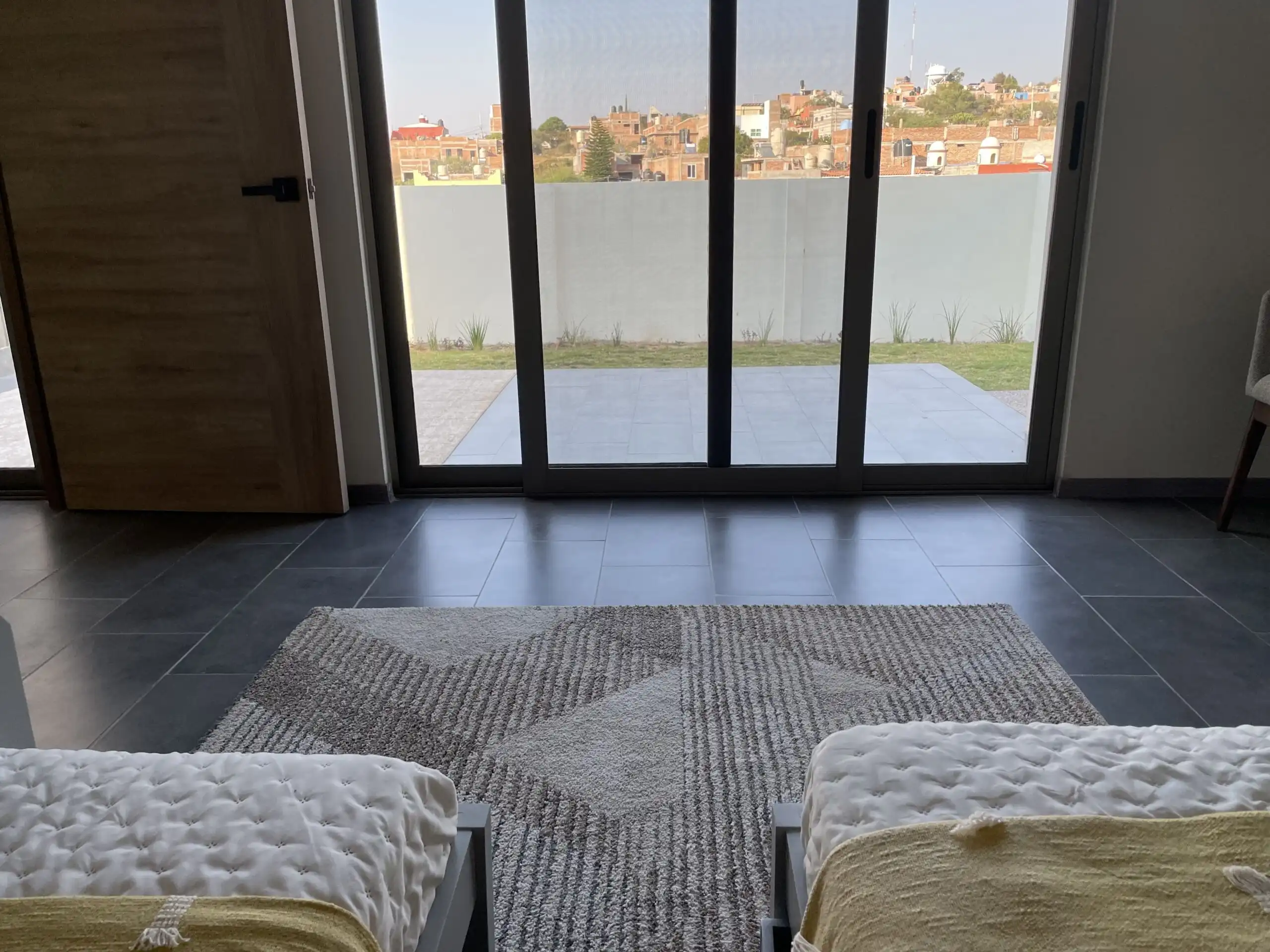 Spacious living room with large glass doors opening to a private terrace.
