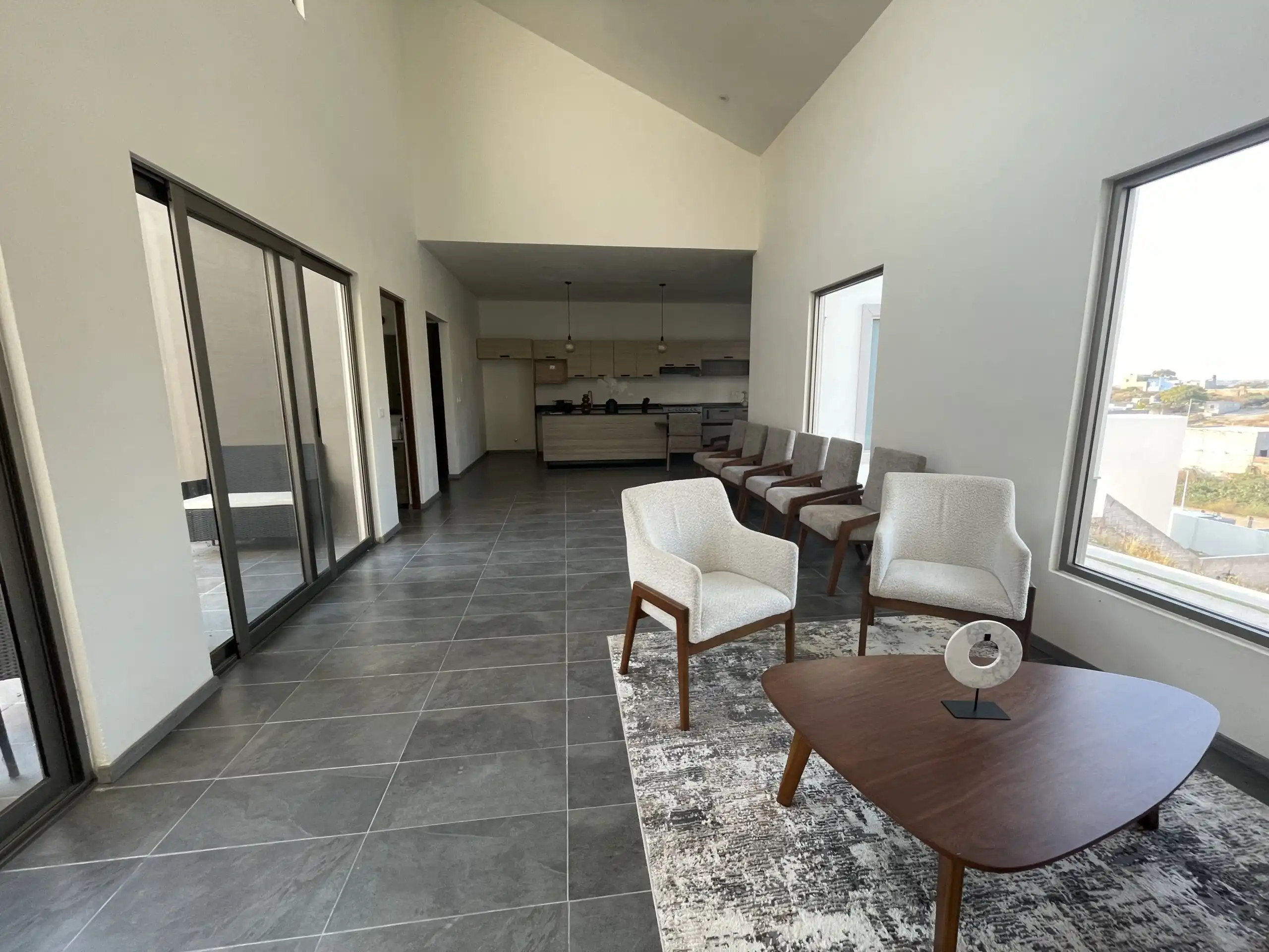 Modern Home Interior in Residencial Barroco Spacious modern living area with large windows and stylish furniture in Residencial Barroco.