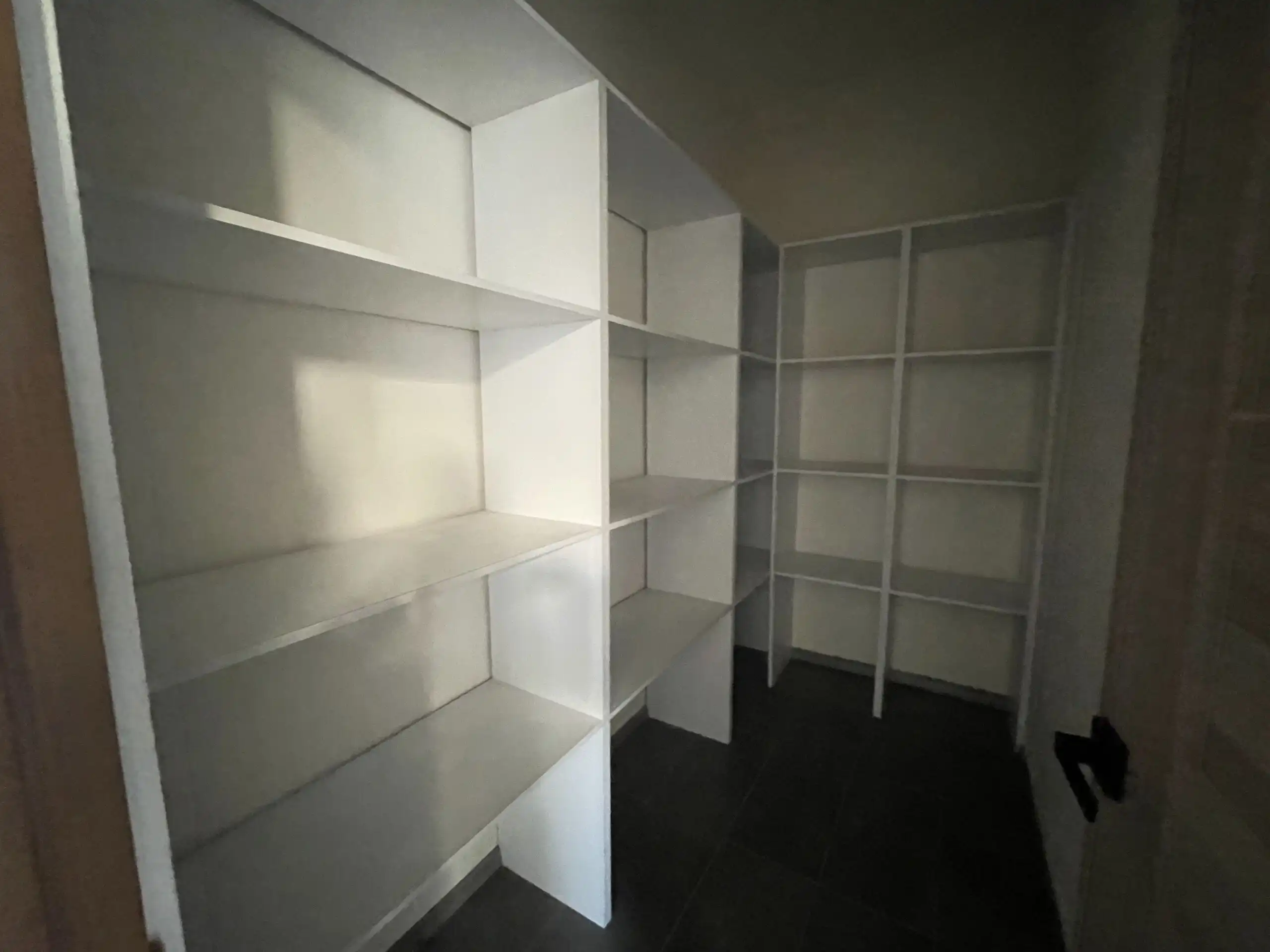 Modern Home Storage Closet Storage closet with white shelves in a contemporary home.