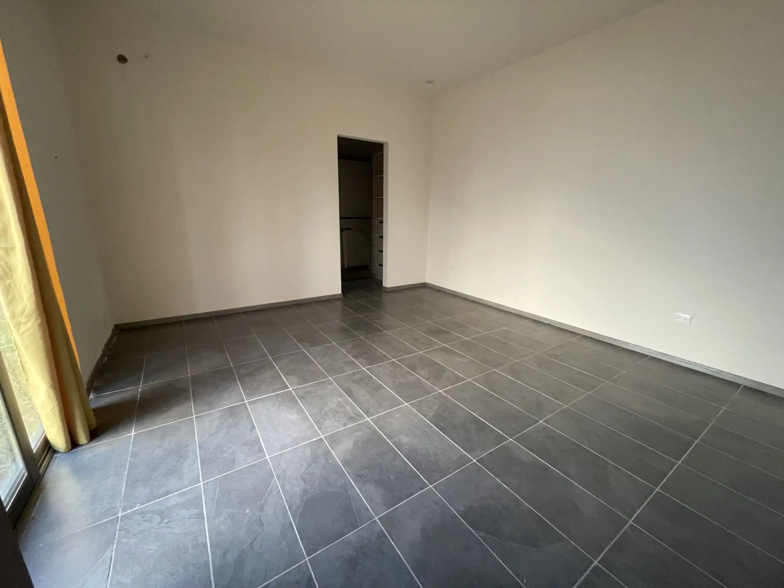 Modern Home Interior in Residencial Barroco Spacious empty room with tiled floor and white walls in Residencial Barroco, San Miguel de Allende.