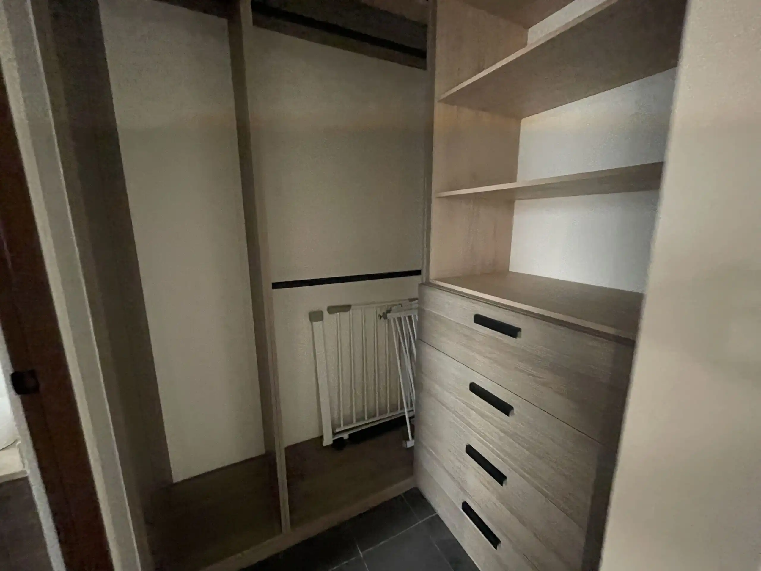 Modern Home Closet Tour Interior view of a modern closet with shelves and drawers in a luxury home.