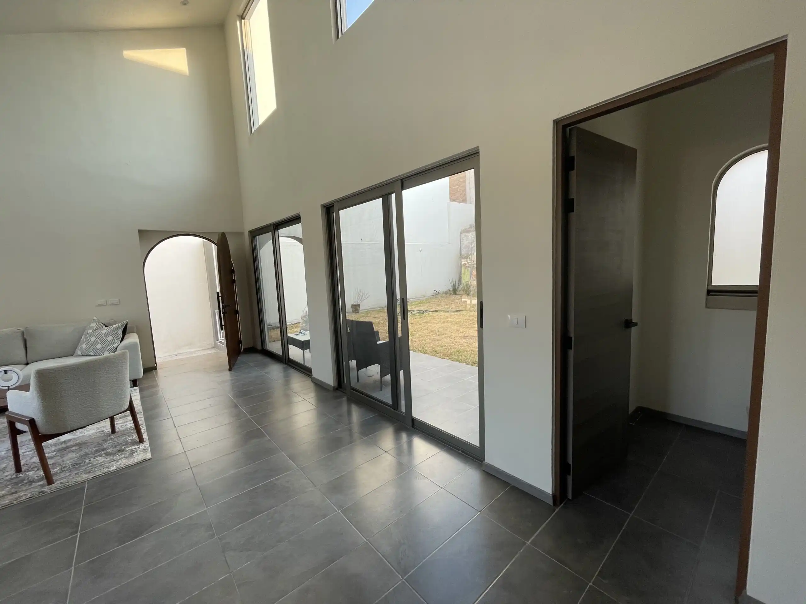 Modern Home Interior in Residencial Barroco Bright living room with large glass doors and high ceilings in San Miguel de Allende.