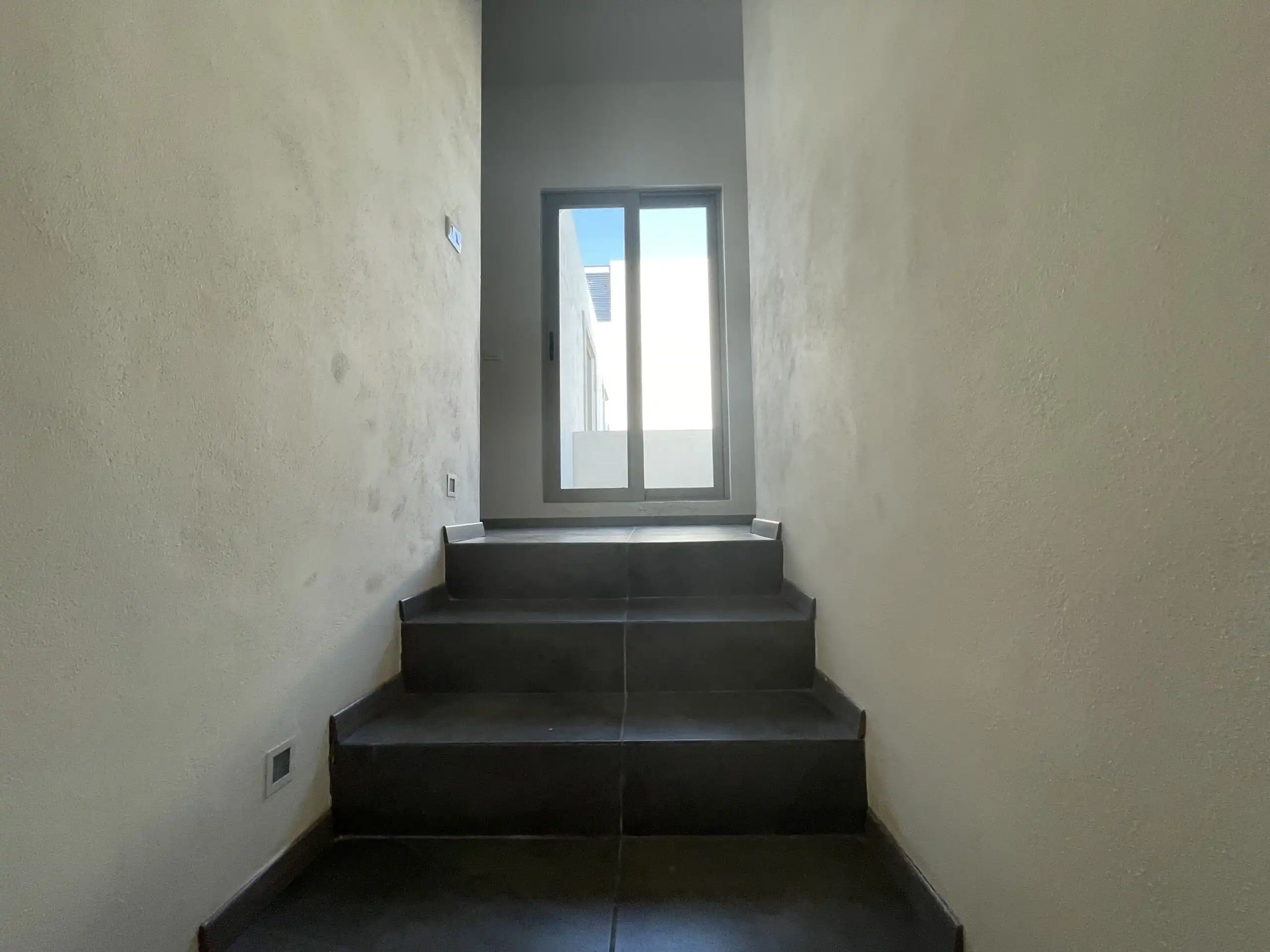 Modern Home Interior Staircase Interior view of modern staircase leading to a glass door in a stylish home.