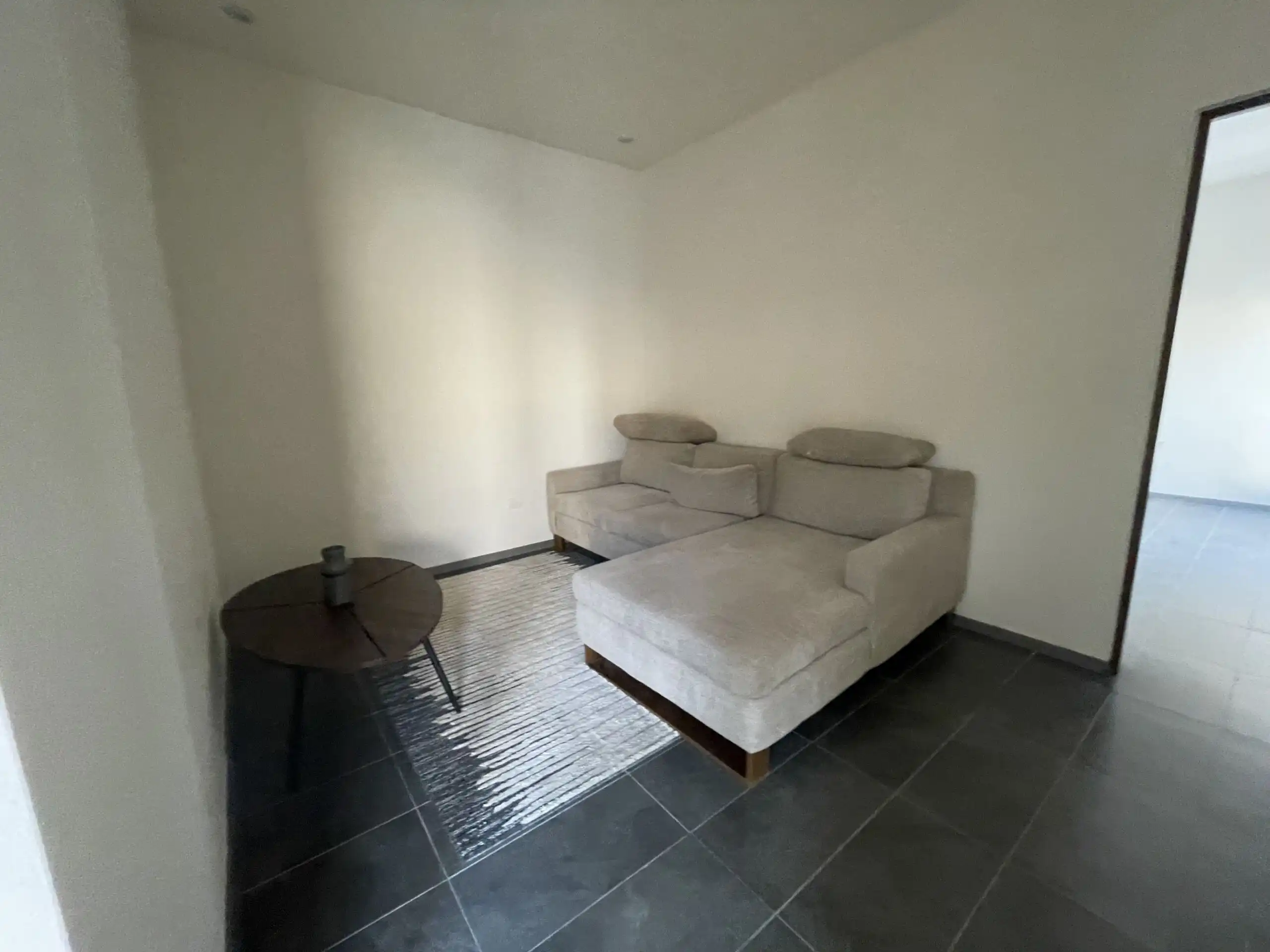 Modern Home Tour in Residencial Barroco Cozy living room with a beige sectional sofa and minimalist decor in San Miguel de Allende.