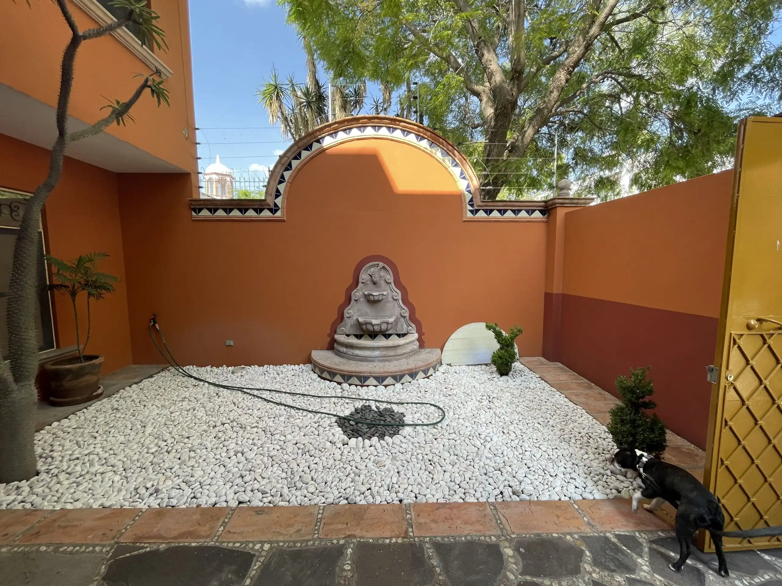 Beautiful courtyard of Los Frailes 3-bedroom home featuring a fountain, garden, and rooftop terrace.