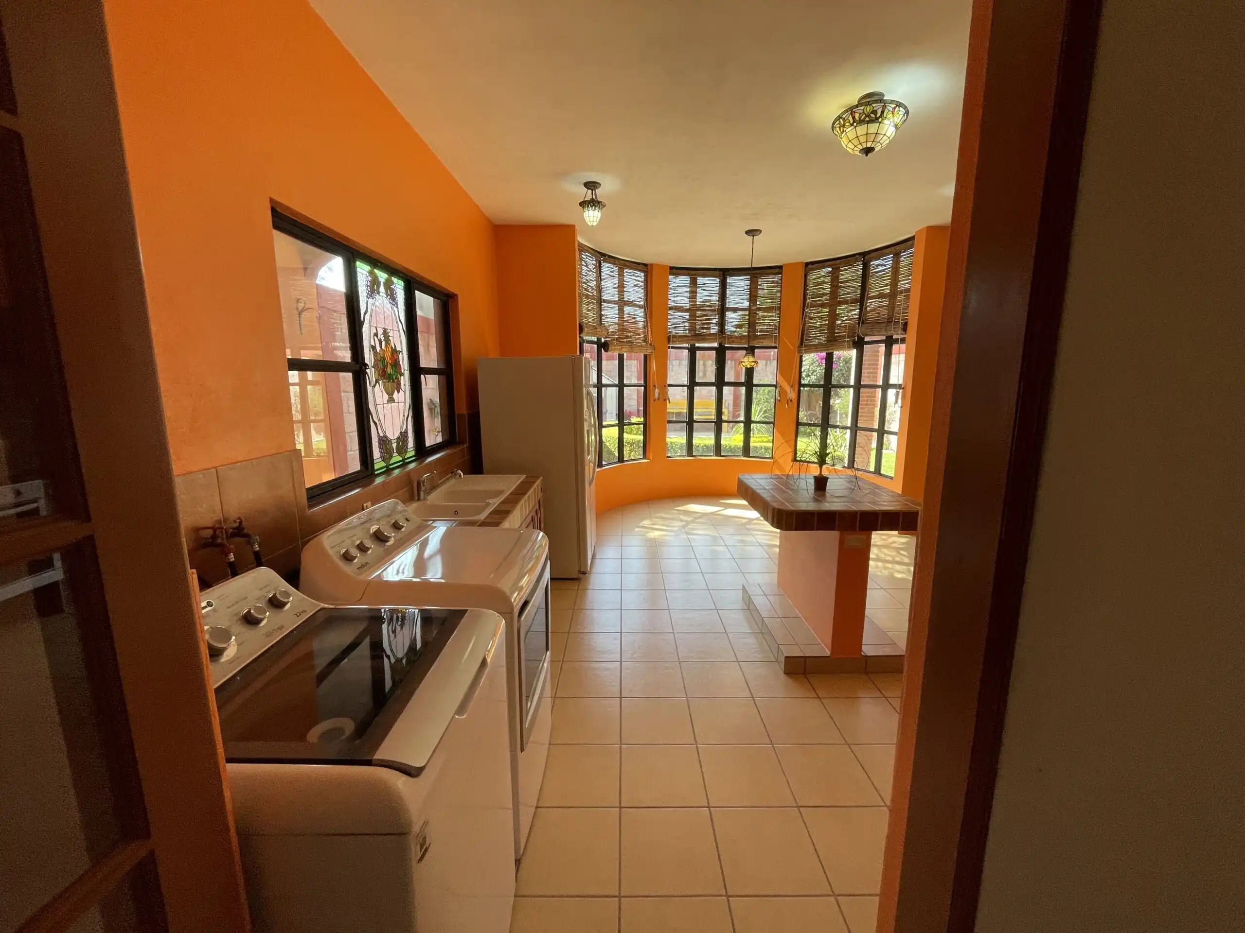 Spacious interior of Los Frailes 3-bedroom home featuring a fireplace, garden, and rooftop terrace.