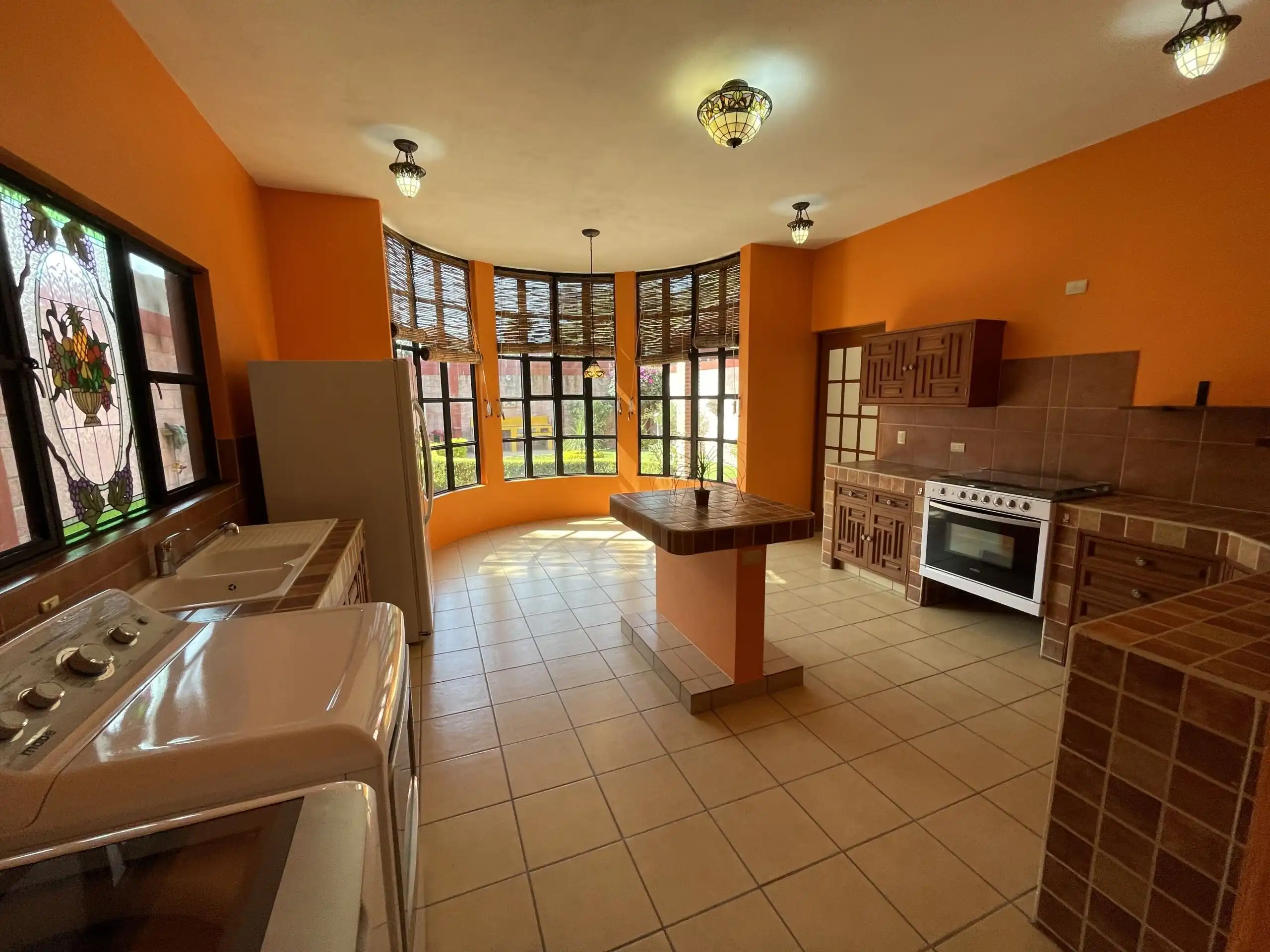 Spacious kitchen with fireplace, garden view, and rooftop access in Los Frailes. Perfect family home.