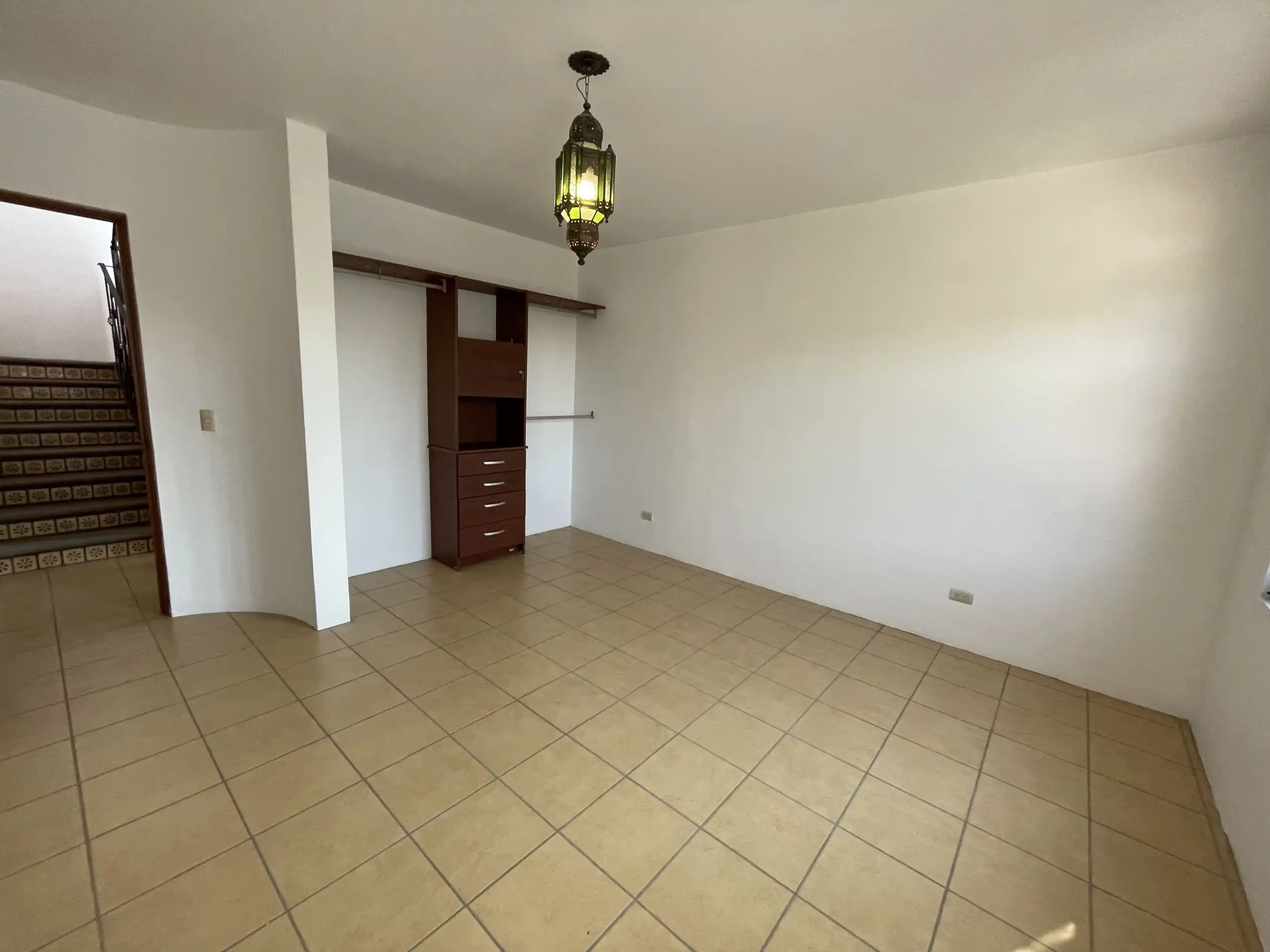 Spacious living area featuring a fireplace, tiled floors, and ample natural light, perfect for relax.
