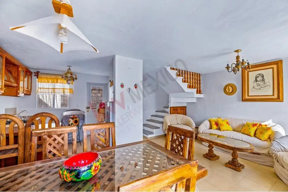 Bright living room with wooden furniture and colorful decor in Bella Vista, San Miguel de Allende.