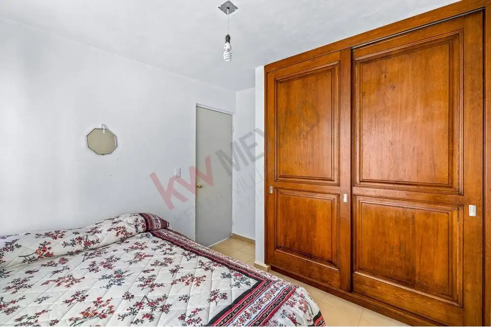 Charming bedroom with wooden wardrobe in a cozy home near Centro, San Miguel de Allende.