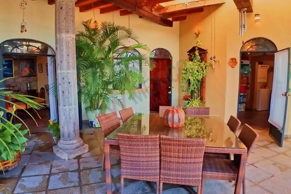 Elegant indoor dining area with lush greenery and rustic decor.