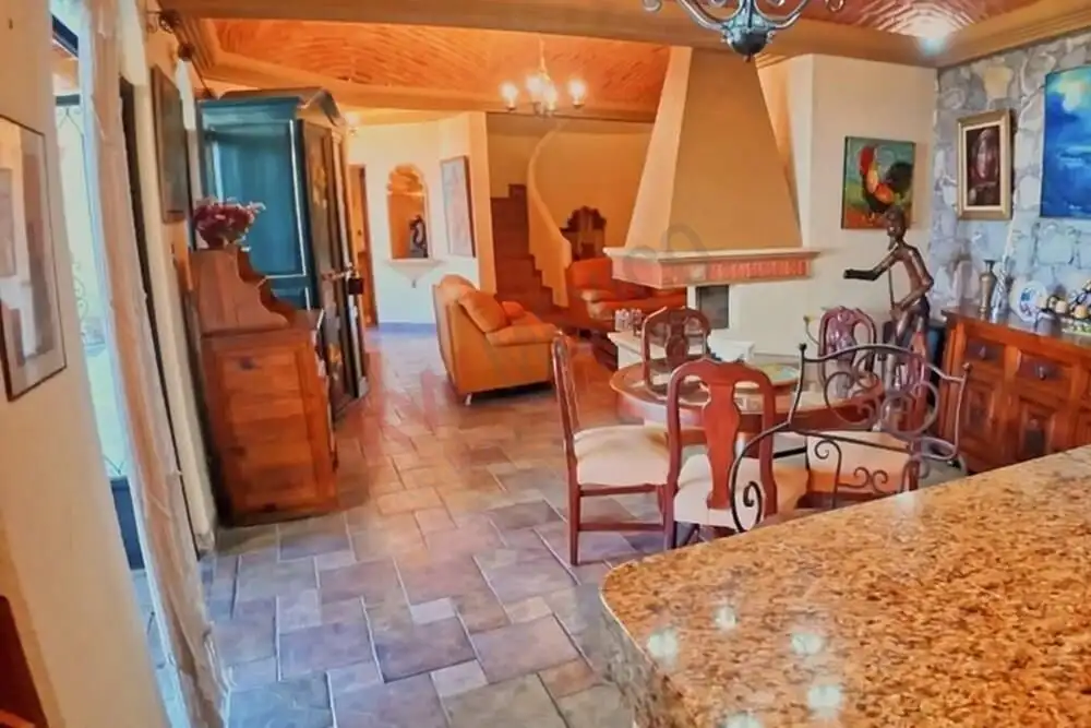 Spacious living room with modern decor, wooden accents, and vibrant artwork in a beautiful San Migue.