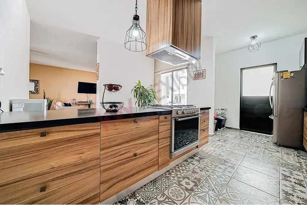 Spacious kitchen with wooden cabinets, modern appliances, and decorative tiles in a beautiful San Mi.
