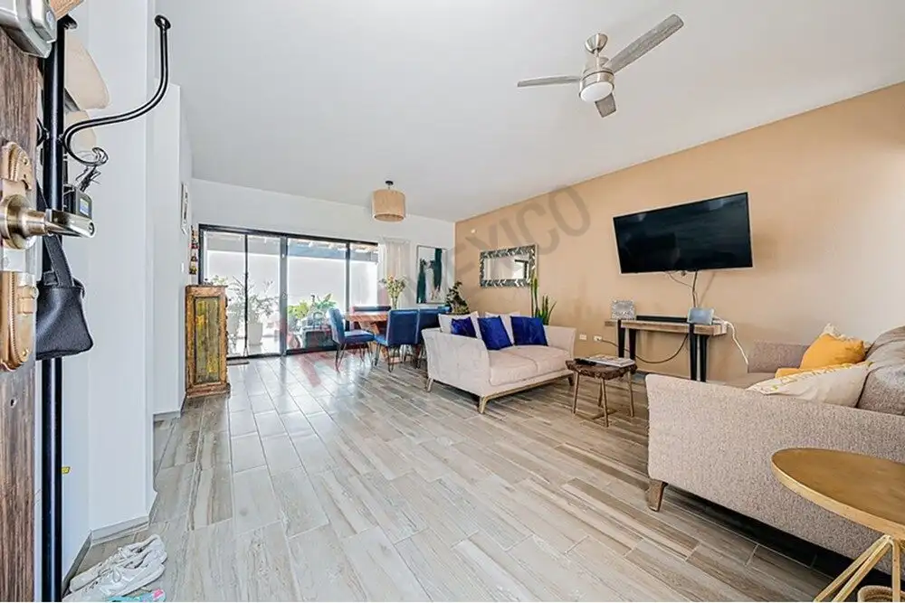 Spacious living room with contemporary furniture and large windows in a modern 4-bedroom home.