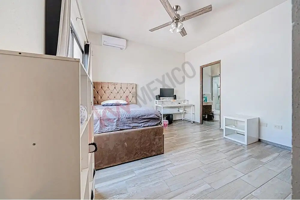 Spacious bedroom with contemporary decor, large windows, and modern furnishings in a beautiful San M.