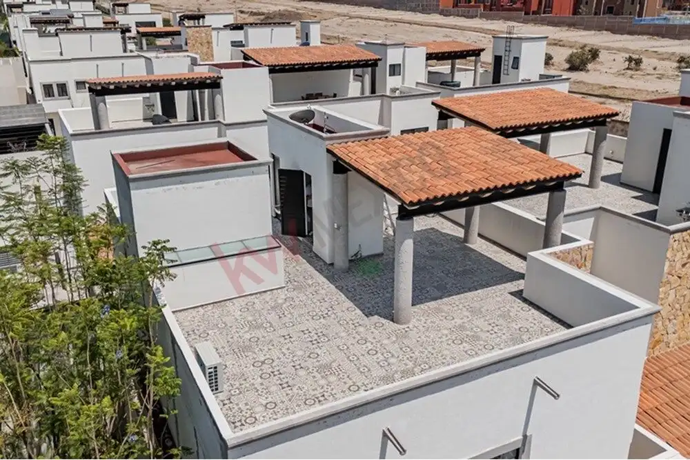 Spacious rooftop terrace with traditional tiled roof accents in a modern 4-bedroom home.