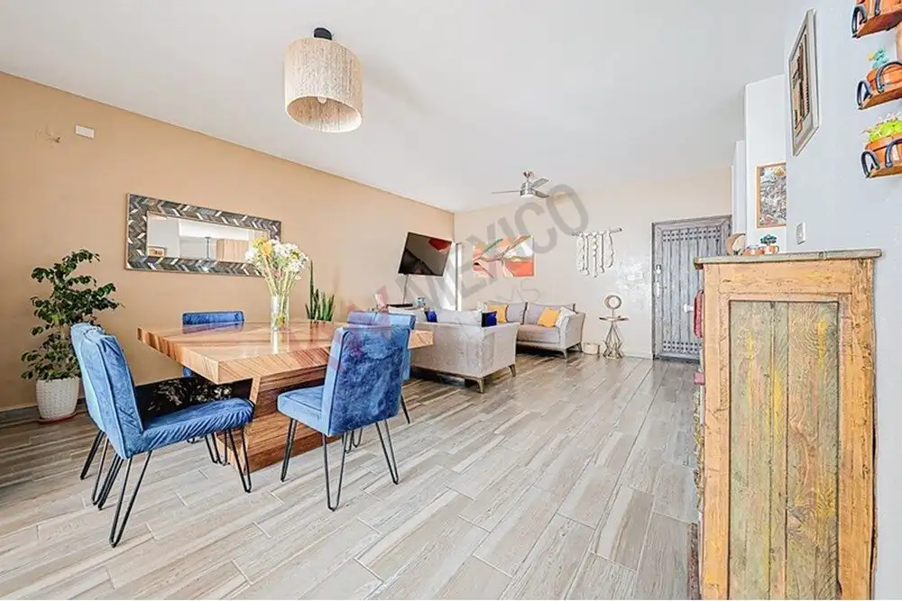 Spacious living room with contemporary decor, wooden flooring, and natural light in a beautiful home.