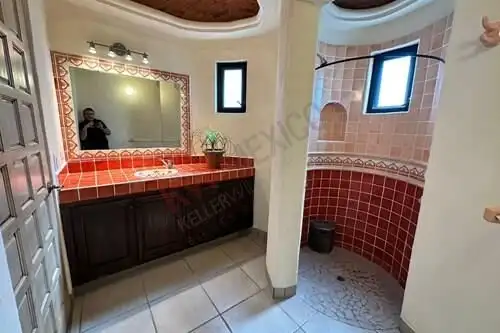 Spacious bathroom with a large mirror, double sink, and separate shower area in Rancho Los Labradore.