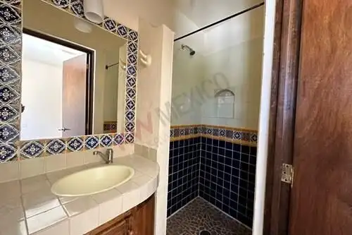Cozy bathroom with tiled shower and vanity in a charming villa in Rancho Los Labradores.