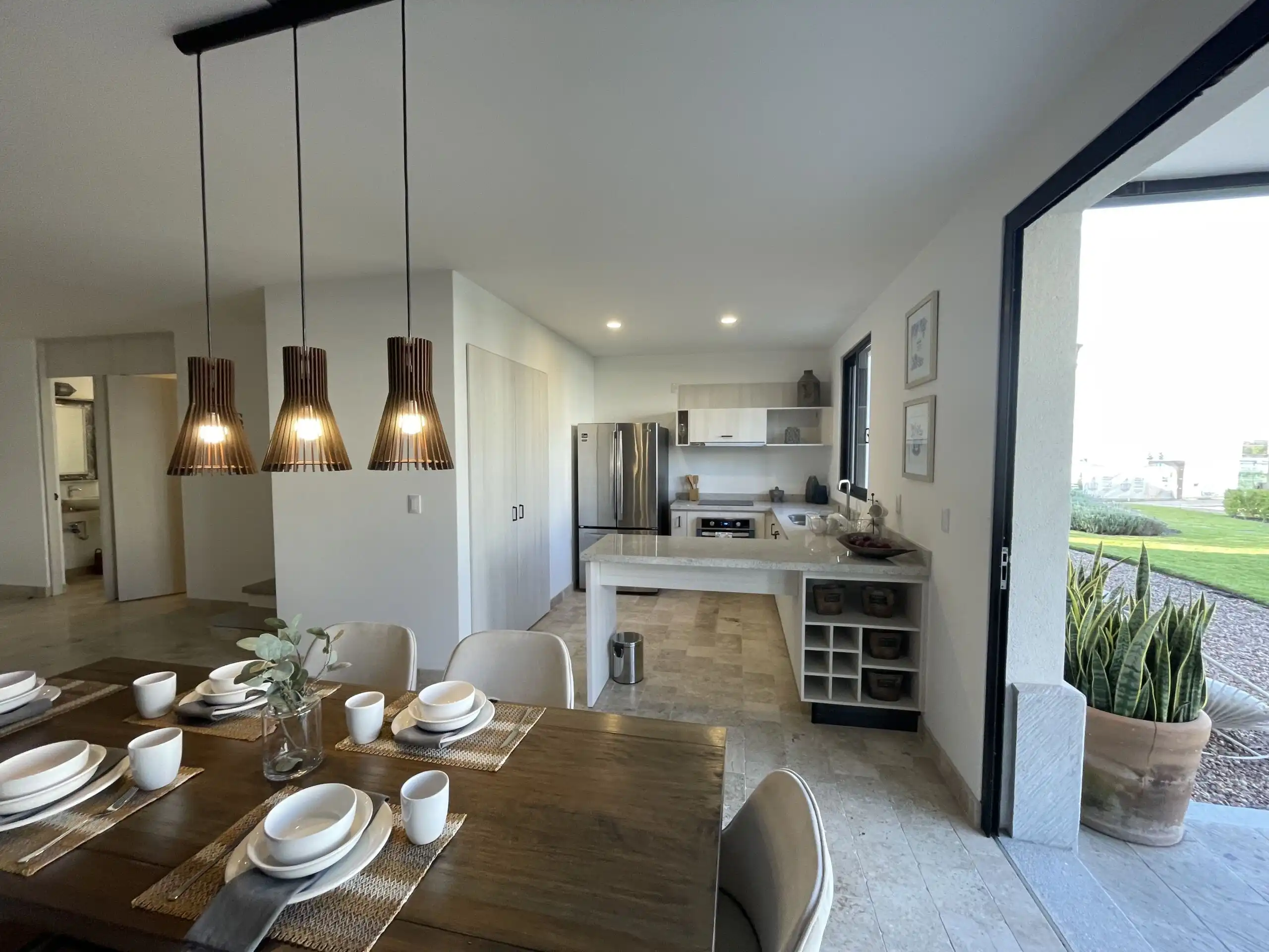 Beautiful modern kitchen and dining area with heated pool view in Casa Santa Elena, La Luminaria.