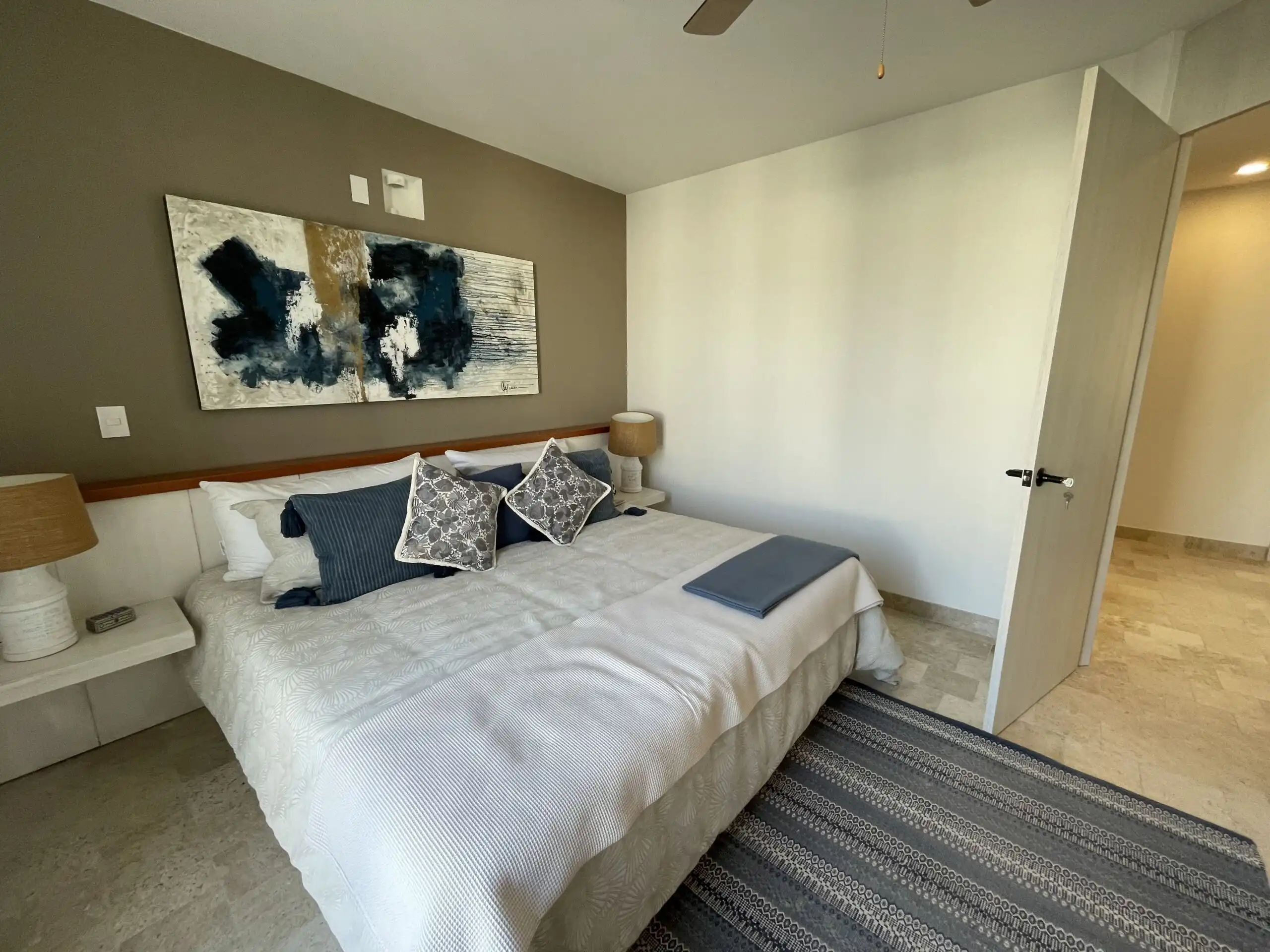 Comfortable bedroom featuring contemporary design and stylish bedding.