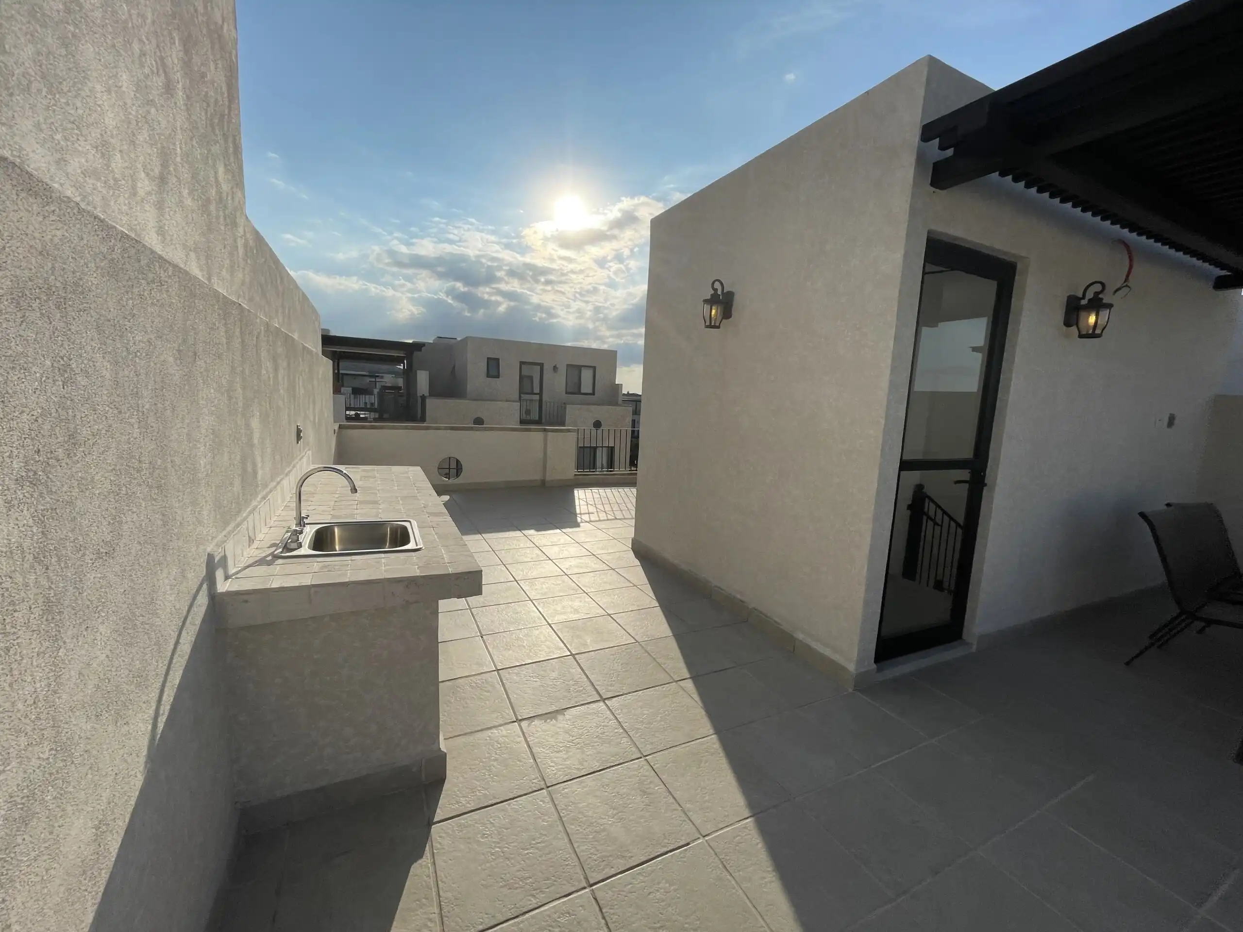 Outdoor rooftop terrace with kitchen and seating area in San Miguel de Allende.